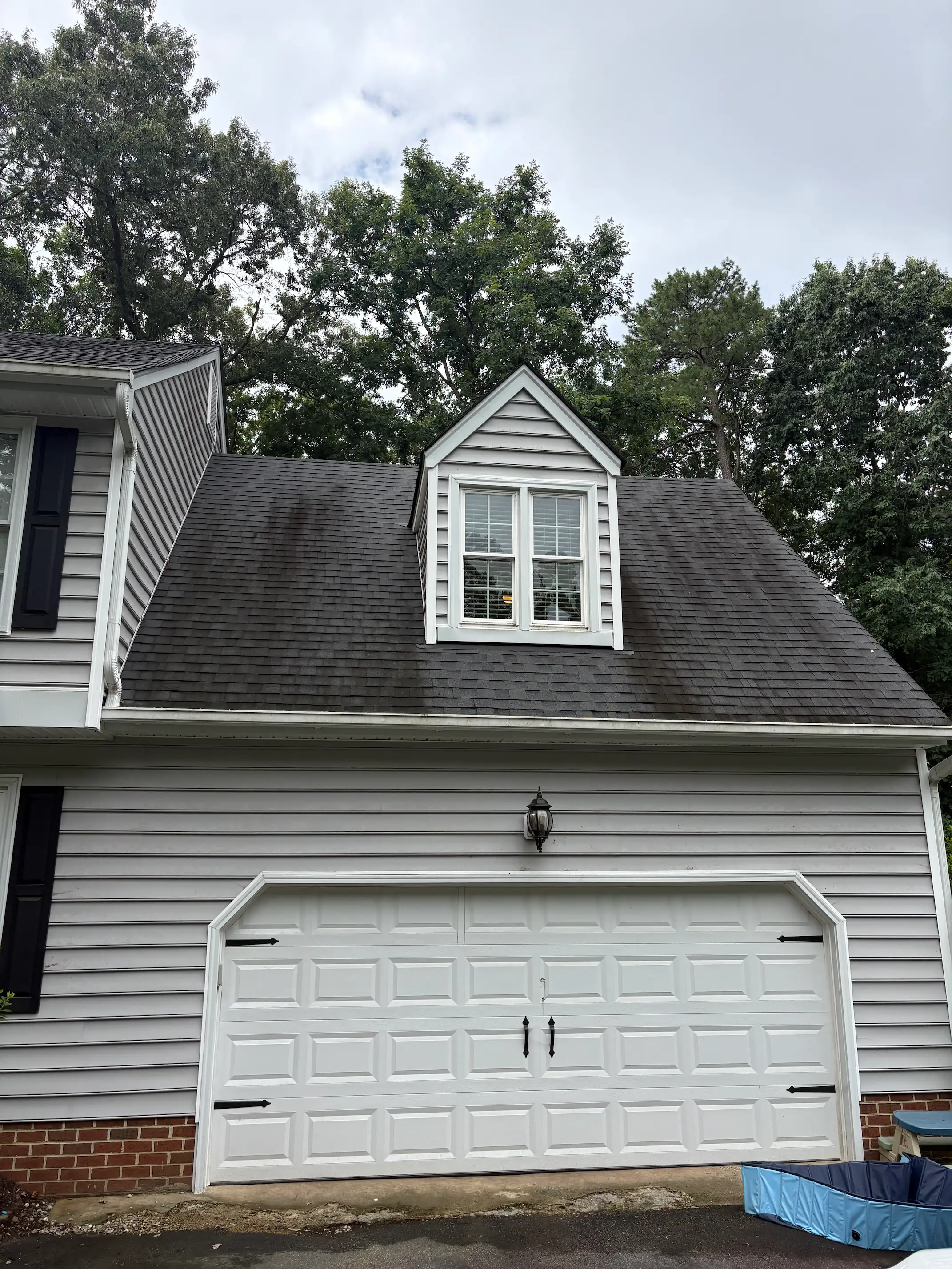 Before: asphalt shingle roof soft washing with black streaks and algae in Richmond VA